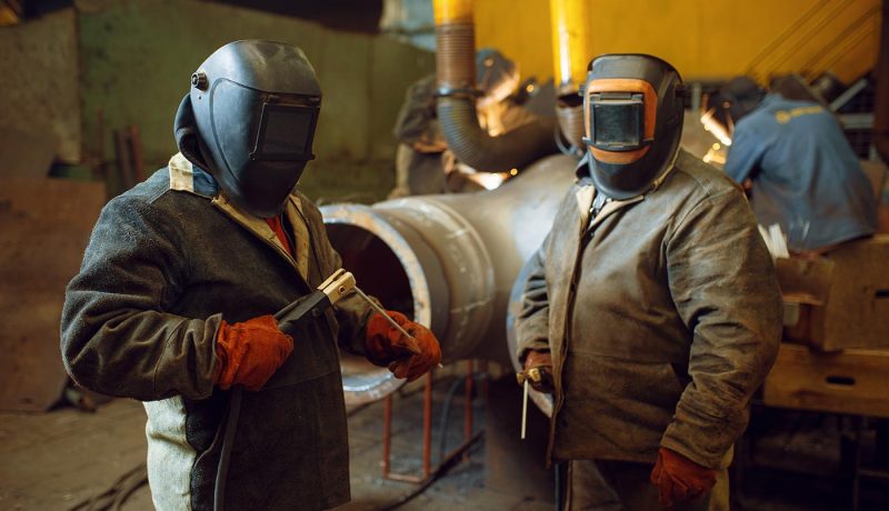two-welder-in-masks-prepares-to-work-with-metal-KTPAD5L